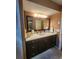Bathroom featuring a modern vanity, elegant lighting and generous counter space at 900 Harbour House Dr, Indian Rocks Beach, FL 33785
