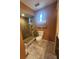 Bathroom showcasing a glass-enclosed shower, toilet, and neutral-toned walls at 900 Harbour House Dr, Indian Rocks Beach, FL 33785