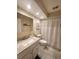 Bright bathroom featuring a shower-tub combination with white tile and a vanity with a speckled marble-like countertop at 900 Harbour House Dr, Indian Rocks Beach, FL 33785