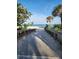 Inviting beach path with wooden walkway leading to the sandy beach and ocean views at 900 Harbour House Dr, Indian Rocks Beach, FL 33785