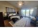 Well-lit bedroom with modern decor, plush rug, and access to a private balcony at 900 Harbour House Dr, Indian Rocks Beach, FL 33785