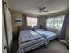 Bright bedroom with two beds, ceiling fan, and natural light at 900 Harbour House Dr, Indian Rocks Beach, FL 33785