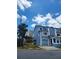 Light blue two-story townhouse with an attached garage and beautiful blue skies at 900 Harbour House Dr, Indian Rocks Beach, FL 33785