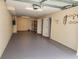 Attached garage with white doors and a gray epoxy floor at 900 Harbour House Dr, Indian Rocks Beach, FL 33785