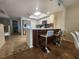 Kitchen island with bar seating, wine rack, white countertops, and stainless steel appliances at 900 Harbour House Dr, Indian Rocks Beach, FL 33785