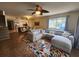 Open-concept living room with a sectional sofa, dining area, and access to the kitchen at 900 Harbour House Dr, Indian Rocks Beach, FL 33785