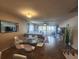Living room featuring dining area, comfortable seating, and a sliding glass door to the outside patio at 900 Harbour House Dr, Indian Rocks Beach, FL 33785