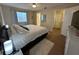 Bright main bedroom features a plush bed, soft lighting, ensuite bathroom access, and a tranquil ambiance at 900 Harbour House Dr, Indian Rocks Beach, FL 33785