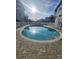 Community pool with deck chairs surrounded by light blue townhouses at 900 Harbour House Dr, Indian Rocks Beach, FL 33785