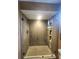 Detail of a glass enclosed shower with tiled walls, built in shelves, and tile floor at 900 Harbour House Dr, Indian Rocks Beach, FL 33785