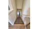 Carpeted stairway leading to the lower level at 900 Harbour House Dr, Indian Rocks Beach, FL 33785