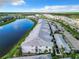 Aerial view of community featuring beautiful landscaping, and a pond with a fountain at 14204 Heritage Landing Blvd # 714, Punta Gorda, FL 33955