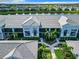 An eye-level aerial view of the backs of condo units, offering serene water views and community landscaping at 14204 Heritage Landing Blvd # 714, Punta Gorda, FL 33955