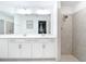 Bathroom featuring double sinks, shower, and large mirror at 14204 Heritage Landing Blvd # 714, Punta Gorda, FL 33955