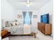 The bedroom has a fan, grey bedding, carpet, and a TV at 14204 Heritage Landing Blvd # 714, Punta Gorda, FL 33955