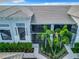 Close aerial view of a condo unit with landscaping featuring palms and other greenery, well maintained complex at 14204 Heritage Landing Blvd # 714, Punta Gorda, FL 33955