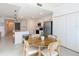 Open-concept kitchen with stainless steel appliances, island seating, and a dining area at 14204 Heritage Landing Blvd # 714, Punta Gorda, FL 33955