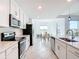 Bright kitchen features stainless steel appliances, quartz countertops, and tile flooring at 14204 Heritage Landing Blvd # 714, Punta Gorda, FL 33955