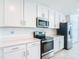 Kitchen features white cabinets, stainless steel appliances, and white countertops at 14204 Heritage Landing Blvd # 714, Punta Gorda, FL 33955