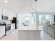 Open concept kitchen with stainless steel appliances, island, and tile flooring at 14204 Heritage Landing Blvd # 714, Punta Gorda, FL 33955