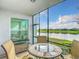 Cozy screened lanai with outdoor seating and tranquil water views at 14204 Heritage Landing Blvd # 714, Punta Gorda, FL 33955