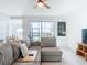 Cozy living room with sliding glass doors to the screened lanai and picturesque water views at 14204 Heritage Landing Blvd # 714, Punta Gorda, FL 33955