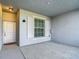 Outdoor patio area with white door, rug, and window with shutters at 14204 Heritage Landing Blvd # 714, Punta Gorda, FL 33955