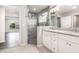 Modern bathroom featuring a glass-enclosed shower and a double vanity with granite countertop at 3067 Newbury St, Port Charlotte, FL 33952