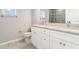 Bathroom features a double vanity with granite countertop and tiled floors at 3067 Newbury St, Port Charlotte, FL 33952