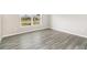 Bright bedroom features gray wood-look flooring and a window at 3067 Newbury St, Port Charlotte, FL 33952