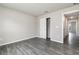 Light-filled bedroom features gray wood-look flooring and a sliding door closet at 3067 Newbury St, Port Charlotte, FL 33952
