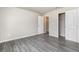 Light-filled bedroom features gray wood-look flooring and a closet at 3067 Newbury St, Port Charlotte, FL 33952