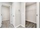 Hallway featuring two doors, one leading to closet with wooden floor and another to a space with tile flooring at 3067 Newbury St, Port Charlotte, FL 33952