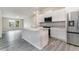 Bright kitchen with granite countertops, stainless steel appliances, and a kitchen island at 3067 Newbury St, Port Charlotte, FL 33952
