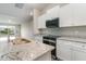 Well-equipped kitchen with granite countertops, white cabinets, and stainless steel appliances at 3067 Newbury St, Port Charlotte, FL 33952