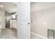 Bright laundry room featuring tile floors, washer/dryer hookups, and access to a modern bathroom with a glass shower at 3067 Newbury St, Port Charlotte, FL 33952
