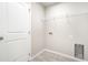 Bright laundry room with tile flooring, white walls, wire shelving and washer and dryer hook ups at 3067 Newbury St, Port Charlotte, FL 33952