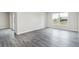 Bright and spacious living area with gray wood floors and sliding door to a patio at 3067 Newbury St, Port Charlotte, FL 33952