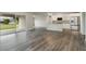 Open-concept living space with gray wood flooring and a modern kitchen at 3067 Newbury St, Port Charlotte, FL 33952