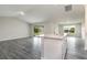 Bright and spacious living area with gray wood floors, leading to sliding doors at 3067 Newbury St, Port Charlotte, FL 33952