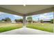 Covered patio offers an outdoor space with a view of the spacious backyard and surrounding neighborhood at 3067 Newbury St, Port Charlotte, FL 33952