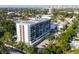 Aerial view of the building showcasing nearby mature trees and parking at 3211 W Swann Ave # 808, Tampa, FL 33609