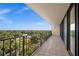 Private balcony showcasing lush green treetop views and black metal railing at 3211 W Swann Ave # 808, Tampa, FL 33609