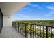Private balcony showcasing lush green treetop views and black metal railing at 3211 W Swann Ave # 808, Tampa, FL 33609