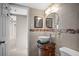 Bathroom featuring vessel sink, decorative tile border and open doorway at 3211 W Swann Ave # 808, Tampa, FL 33609