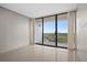 Bright bedroom featuring sliding glass doors to a balcony with city views at 3211 W Swann Ave # 808, Tampa, FL 33609