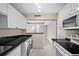 Well-equipped kitchen with black countertops, stainless steel appliances, washer/dryer, and an open view to the living area at 3211 W Swann Ave # 808, Tampa, FL 33609