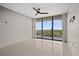 Open living room with large sliding glass doors leading to private balcony at 3211 W Swann Ave # 808, Tampa, FL 33609