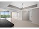 Bright, open living space with tile flooring, a modern chandelier, and sliding glass doors to a balcony at 3211 W Swann Ave # 808, Tampa, FL 33609