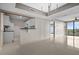 Open living space featuring tile floors, neutral walls, and a pass-through kitchen area with views to the outside at 3211 W Swann Ave # 808, Tampa, FL 33609